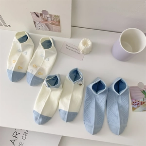 Detail of blue and cream cotton ankle socks with cute animal embroidery and ribbed cuffs