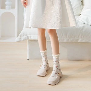 Women's summer mesh socks with floral ruffles paired with white Mary Jane shoes
