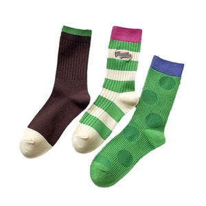 Three pairs of patterned cotton crew socks with ribbed cuffs and Good Luck embroidery details