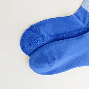 Detailed close-up of thick terry sole on navy cotton socks for enhanced comfort