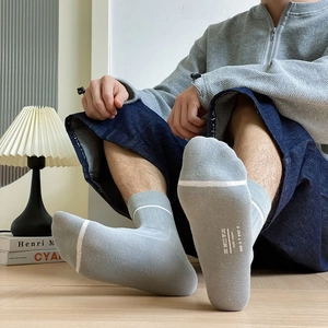 Light gray cotton crew socks with white ankle stripe and comfortable knit texture