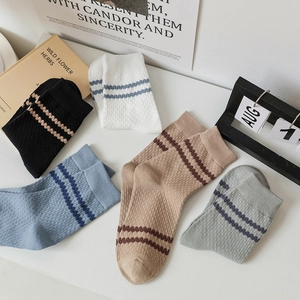 Five pairs of men's cotton crew socks with athletic stripes in assorted neutral colors