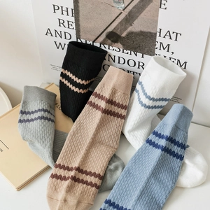 Five pairs of men's cotton crew socks with striped cuffs and mesh knit pattern