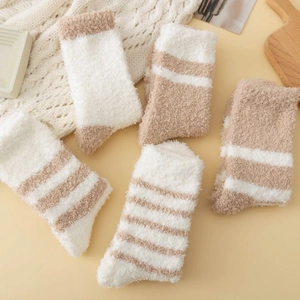 Close-up of thick coral fleece winter socks in cream and coffee tones with soft texture