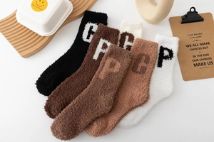 Set of five plush coral fleece socks in warm earth tones featuring knitted letter detail