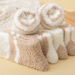 Macro shot of fluffy striped coral fleece socks showing soft plush texture and warmth