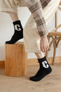 Detailed texture of thick black coral fleece socks with C letter embroidery on the side