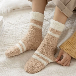 Detail of high-elastic thick coral fleece winter socks with white horizontal stripes