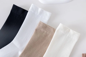 Detailed view of high-elastic cotton crew socks in black, white, and khaki tones