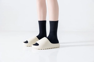 Detail of chunky platform slide sandal featuring thick anti-slip serrated sole in beige