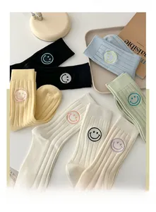 Detail of colorful cotton crew socks with embroidered smiley face in five fresh colors