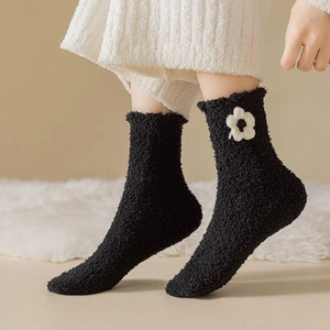Plush black coral fleece socks with white 3D flower detail for warm winter home wear