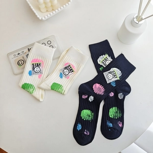 Mid-calf cotton socks with colorful dots and Stay Happy smiley label for women