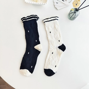 Japanese style frilly socks with floral knit patterns in black and white colors