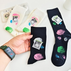 Chic knit crew socks with colorful polka dots and Stay Positive smiley woven patch