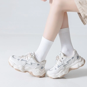 White chunky platform sneakers for women with mesh panels and sporty casual design