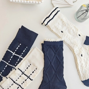 Detailed knit texture of Lolita floral socks with navy and beige diamond patterns