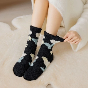 Detail of soft coral fleece thermal socks with colorful cloud patterns and plush texture