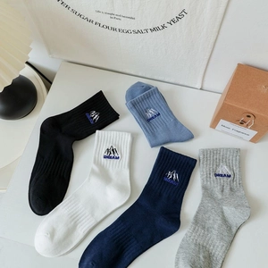 Detail of cotton crew socks featuring embroidered mountain logo and DREAM lettering