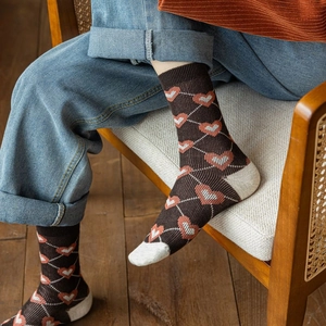 Detail of vintage heart pattern mid-calf socks with cream heel and toe accents