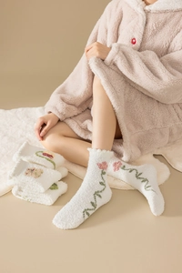 Thick coral fleece winter socks with tulip embroidery on soft beige plush fabric