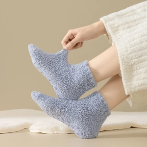 Close-up of elastic light blue fleece socks showing non-slip dots and soft warm texture
