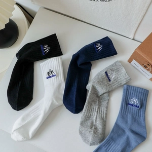 Five pairs of rib-knit cotton socks in black, navy, grey, blue, and white with DREAM embroidery