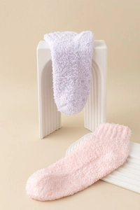 Detailed view of non-slip coral fleece socks in soft pastel colors with anti-skid dots