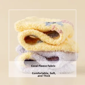 Detail of thick coral fleece socks in soft yellow and purple with cozy plush texture