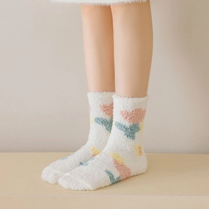 Close-up of thick white coral fleece socks featuring colorful tulip floral patterns