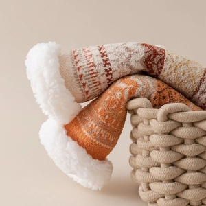 Detail of winter sherpa-lined thermal socks with geometric knit pattern in a basket