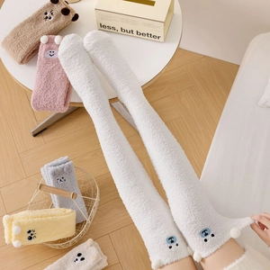 Detailed view of colorful over-the-knee coral fleece socks with cute 3D animal ear decorations