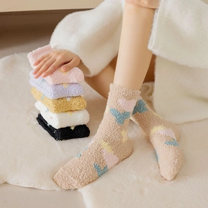 Detailed texture of thick coral fleece socks with colorful geometric patterns for winter