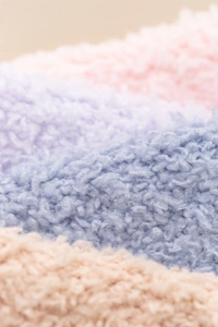 Detailed macro view of soft coral fleece texture on thick winter thermal socks