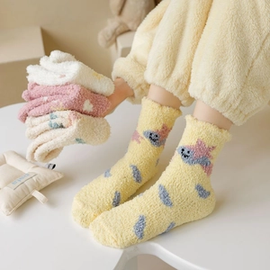 Detail of soft thick coral fleece socks with cute star and dinosaur cartoon patterns