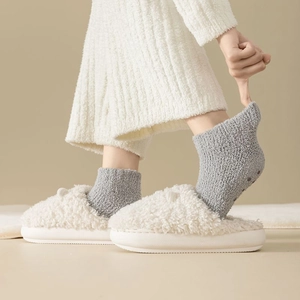 Close-up of soft gray coral fleece socks with non-slip grips for indoor home comfort