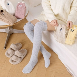 Detailed texture of thick coral fleece over-knee socks with cute animal ear embroidery