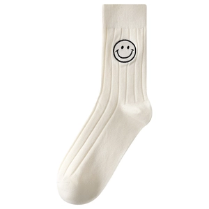 White cotton slouch socks with vertical ribbing and a black embroidered smiley face