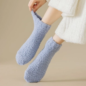 Detail of light blue coral fleece socks showing soft plush texture and elastic ribbed cuffs