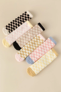 Flat lay of six pairs of checkered coral fleece socks in assorted soft pastel colors