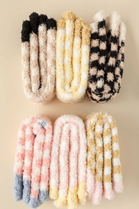 Detailed view of six pairs of thick coral fleece socks with colorful plaid patterns