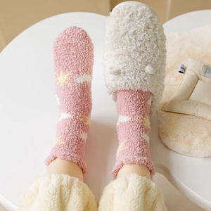 Detailed texture of thick pink coral fleece socks with cute star patterns and plush slippers
