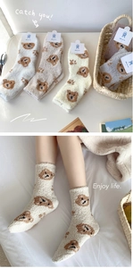 Detail of five pairs of warm coral fleece crew socks with cute bear patterns