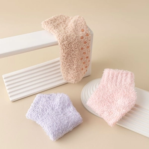 Women's warm coral fleece floor socks with anti-slip silicone grippers in soft pastel colors