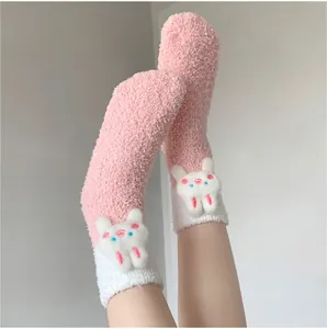 Detail of coral fleece thick warm socks featuring a 3D cute rabbit doll attachment