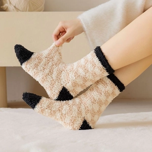 Close-up showing the high elasticity and soft texture of thick coral fleece winter socks