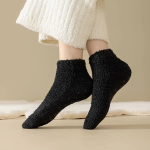 Women's warm black coral fleece house socks with non-slip silicone grips on the bottom