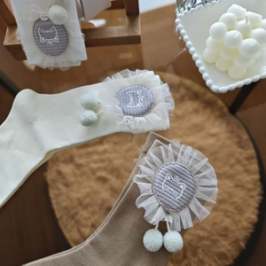 Japanese Lolita style knee-high socks with cat embroidery, lace ruffles and pom-poms