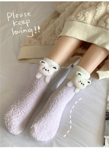 Close-up of thick coral fleece socks with 3D teddy bear detail and gradient purple finish