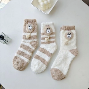 Detail of coral fleece thick striped socks featuring a cute 3D cartoon bear design